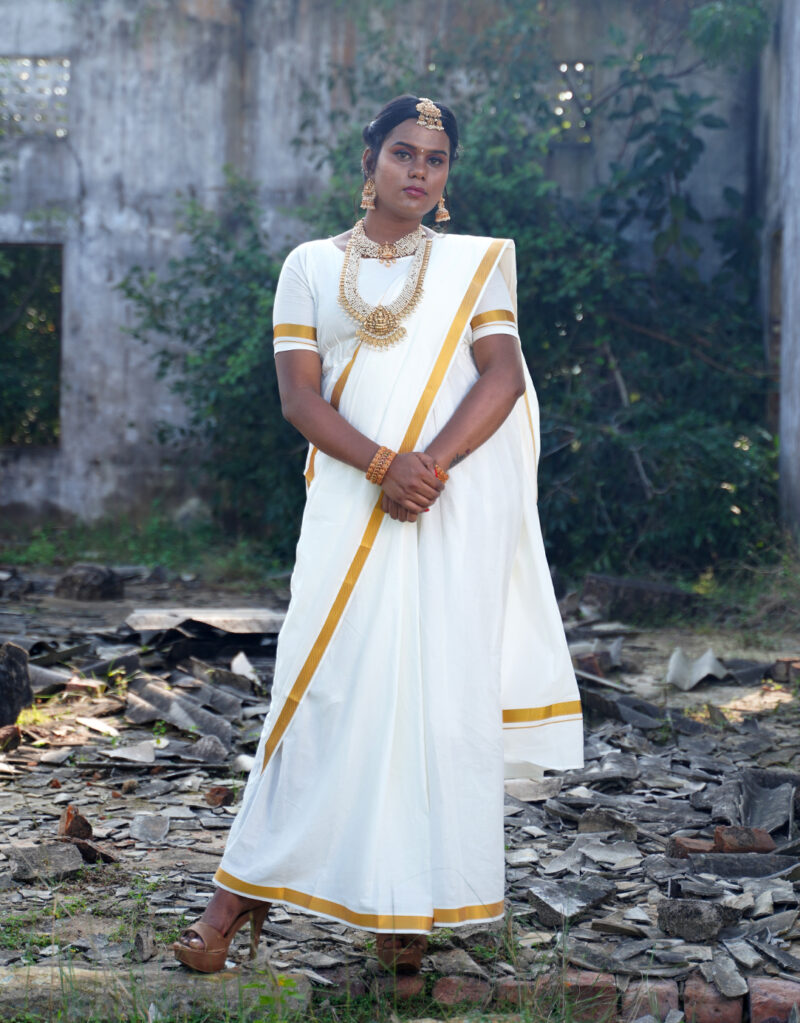 Saree-inspired dress with pleated skirt front, tailored mundhanai/pallu with sleeves, and double side pockets. Fabric: Handloom Cotton, Colour: Cream with gold jari border 1"