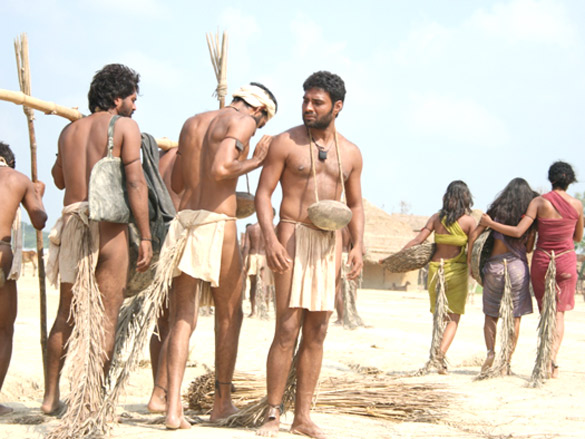 A still from the movie Shudra - The Rising, depicting the clothing of untouchables in Poona. In the Peshwe capital of Poona, the outcastes/avarnas were required to tie a broom to their waist and carry an earthen pot hung from their neck