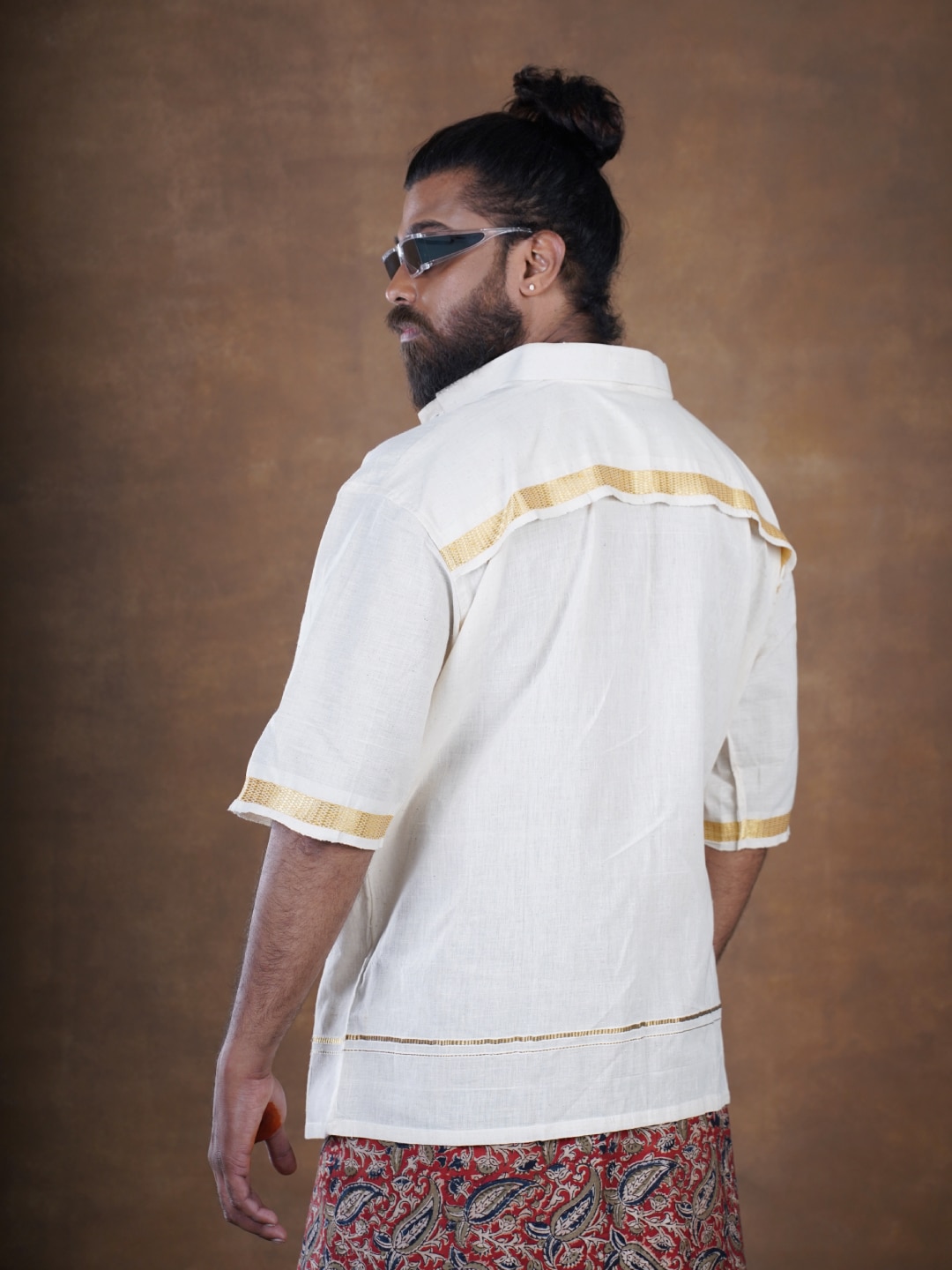 Freedom Shirt in Seashell Beige, featuring a golden jari border and eco-friendly coconut shell buttons, crafted from handwoven cotton for a gender and body-fluid oversized fit.